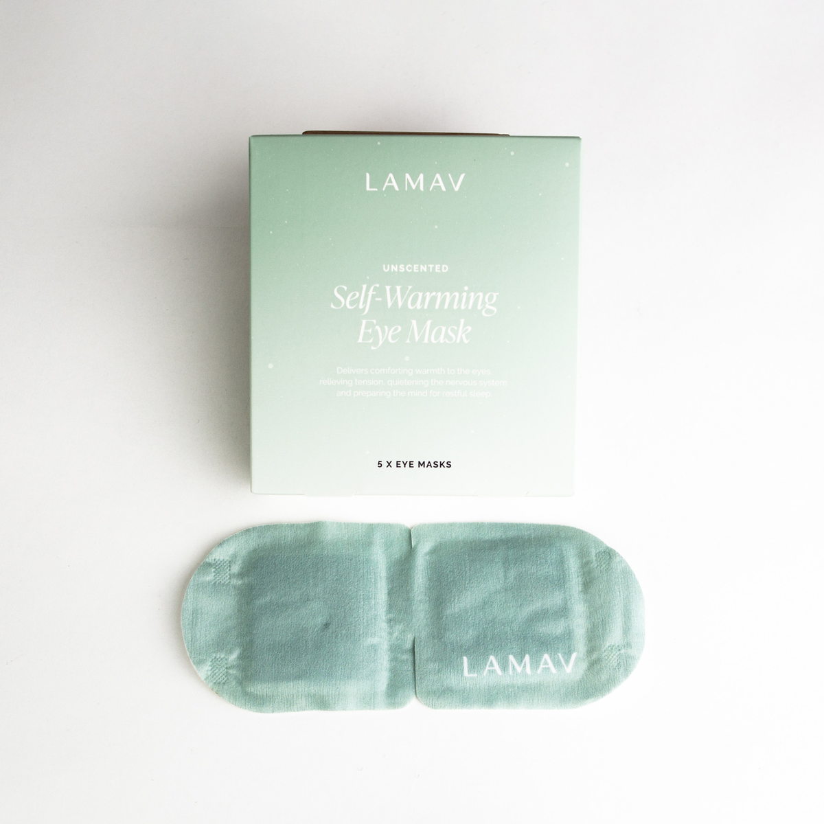Single-use heated eye mask with ear loops beside its sachet